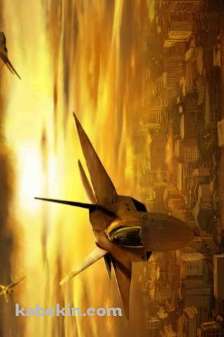 夕暮れの街の上を飛ぶ戦闘機のAndroidの壁紙(320px x 480px) スマホ用