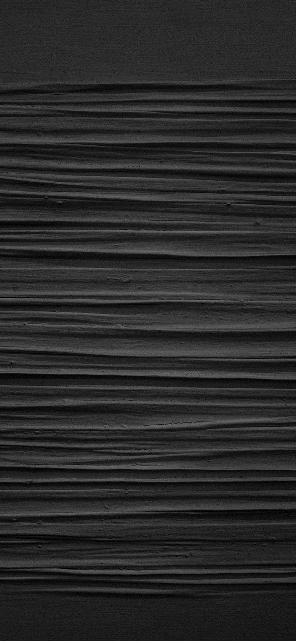 黒い凹凸のある壁の1170 x 2532 / スマホ壁紙