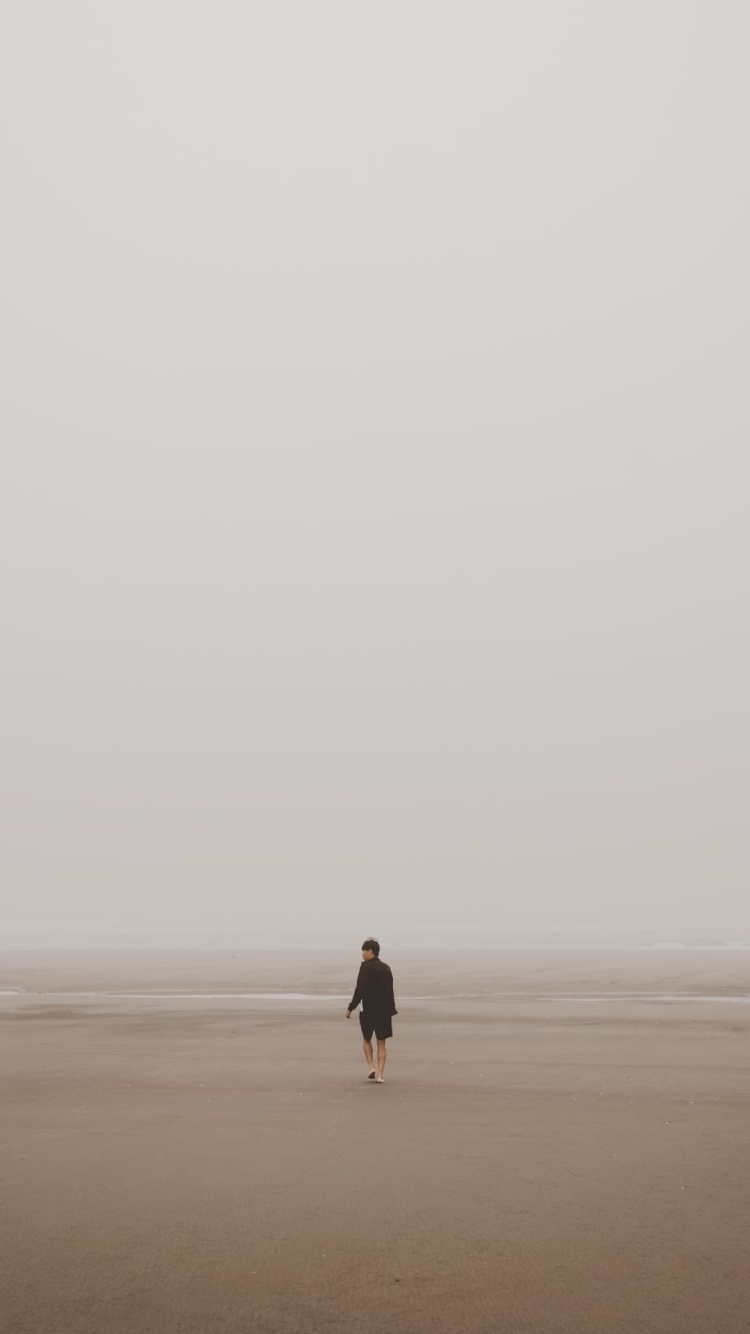 海辺 砂浜を歩く男性の750 x 1334 / スマホ壁紙