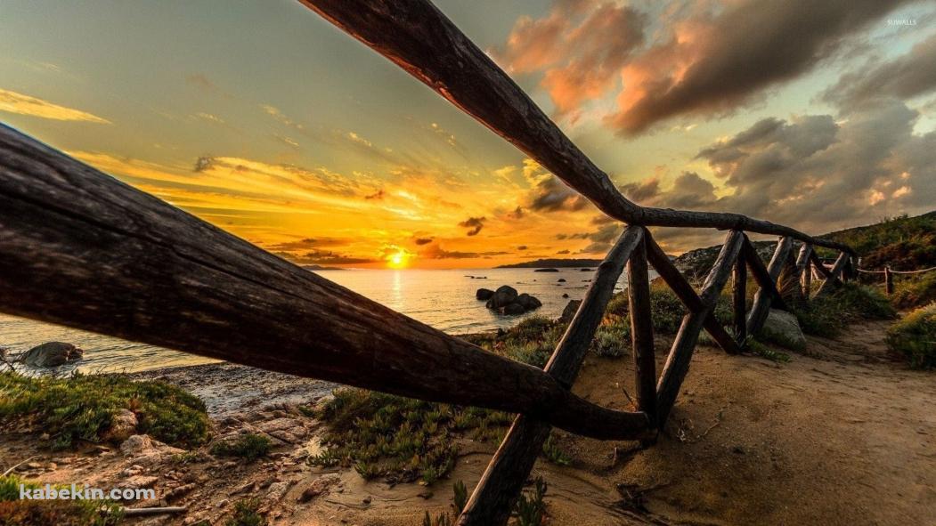木のフェンス越しに見える綺麗な海と夕陽の壁紙(1051px x 591px) 高画質 PC・デスクトップ用