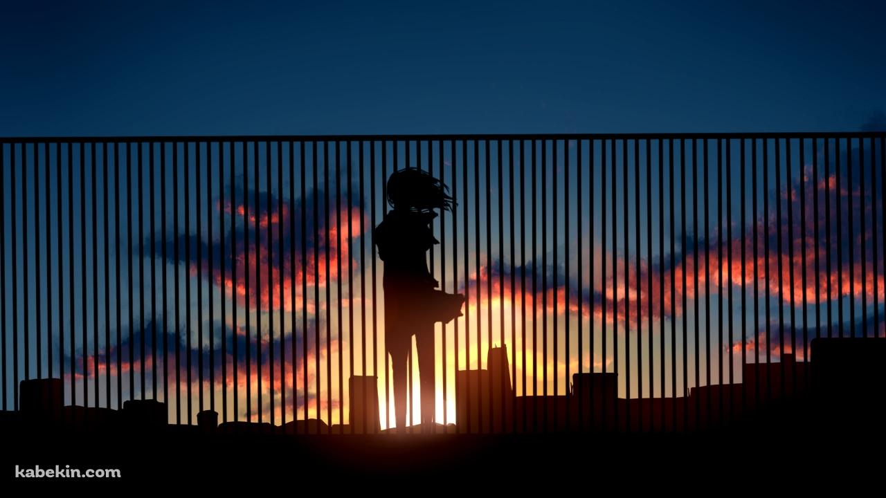 ビルの屋上の柵越しから夕陽を眺める女性の壁紙(1280px x 720px) 高画質 PC・デスクトップ用